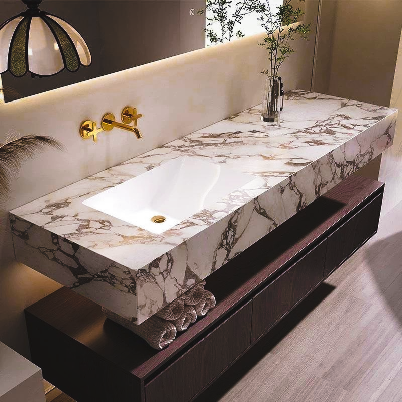 Calacatta marble bathroom vanity with gold faucet